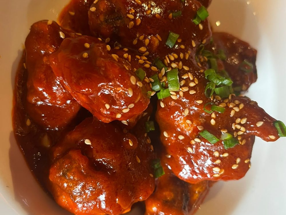 Crispy Korean fried chicken in a glossy sauce at Hokkaido, Indiranagar
